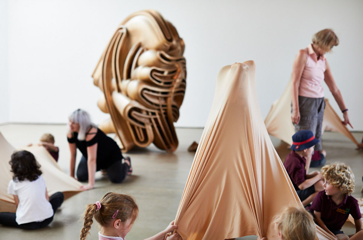 A workshop in a studio with children playing with sculptural objects and materials