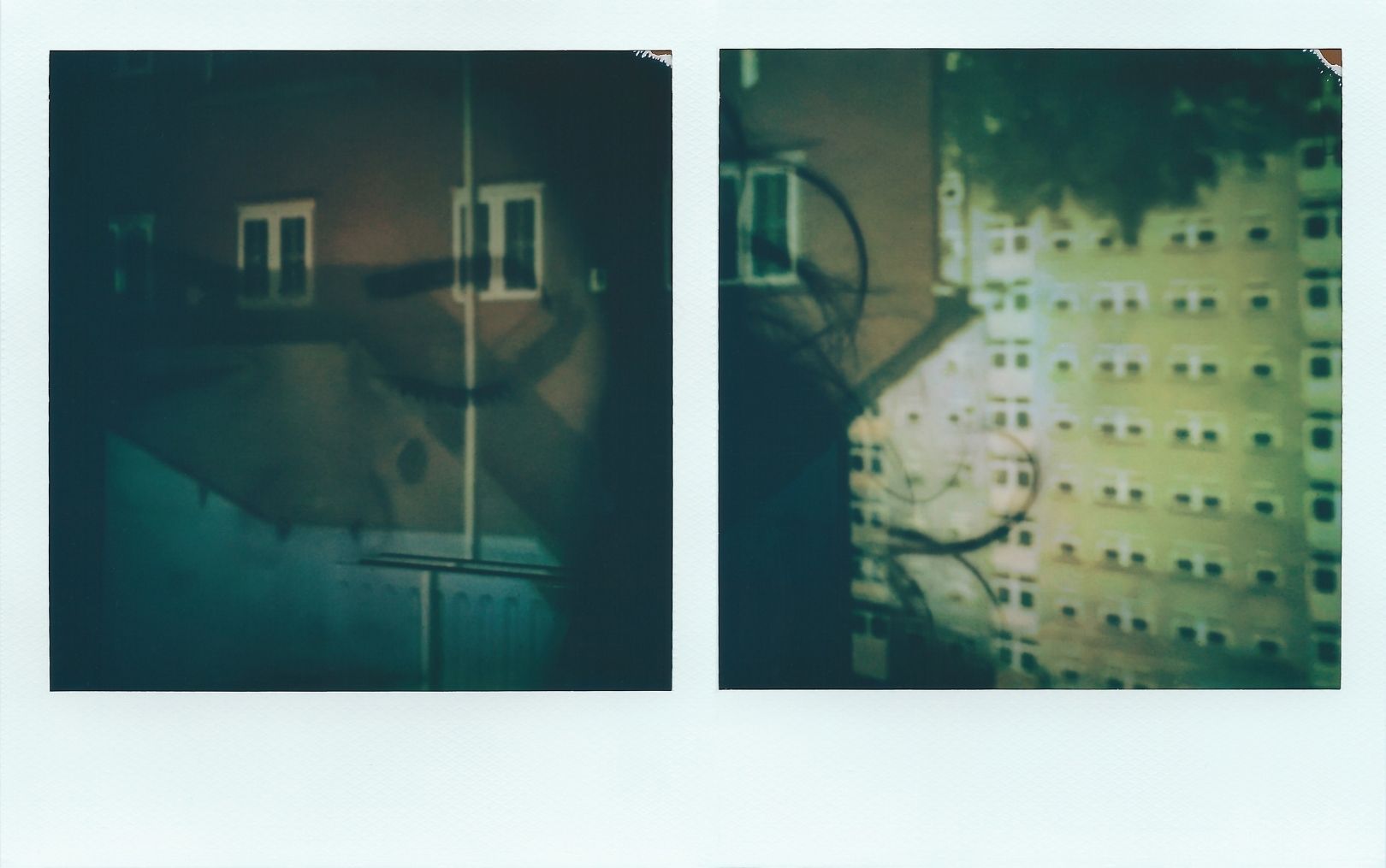 A polaroid duo of an upside-down image of a two storey house (left) and high-rise block of flats (right). This image appears upside-down on an inside wall, where a lamppost cuts onto the room’s radiator. Someone’s hair appears as a shadow that is positioned centrally between the two polaroids. The colours are mostly browns, cream and hints of blue