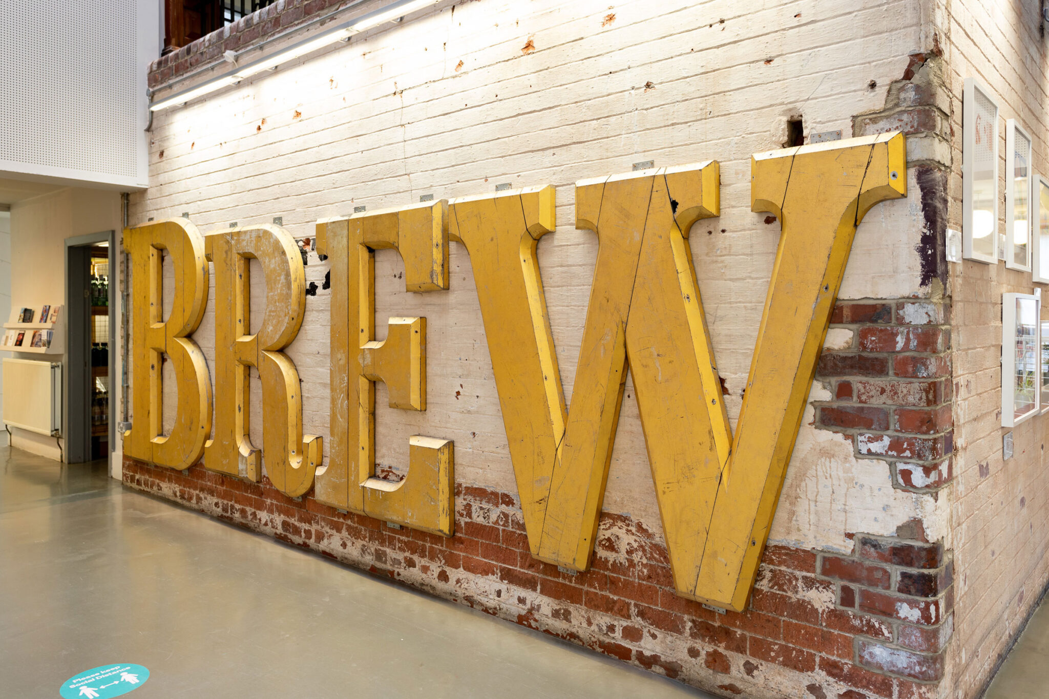 Gold letters 'Brew' on The Tetley interior wall