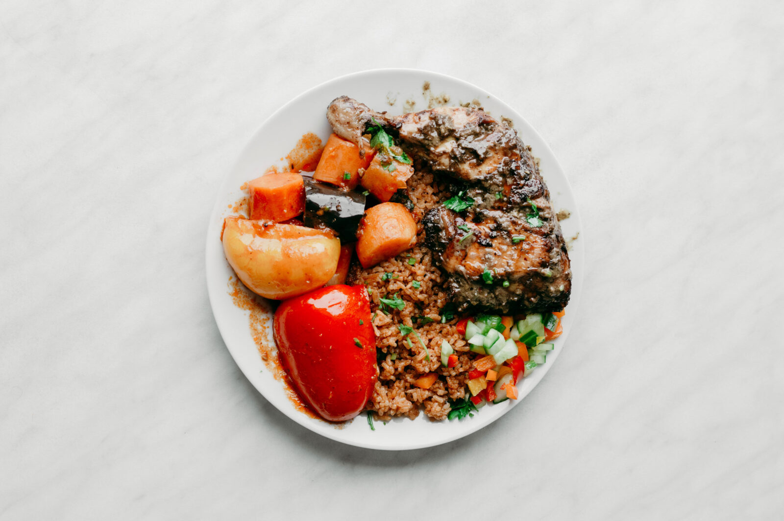 A plate of food including jerk chicken