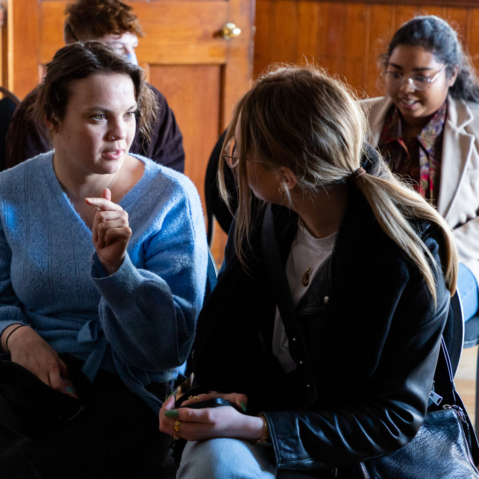 A group of people sat in a talk at The Tetley