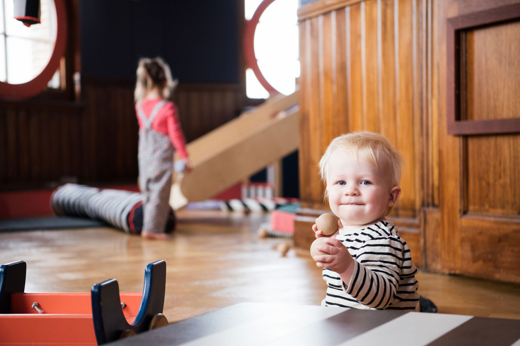 A Baby smiles at camera in Tiny Tetley Studio