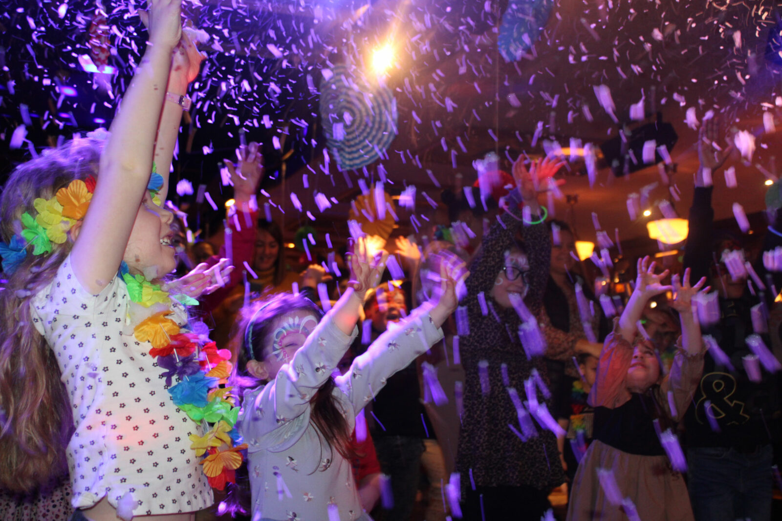Children dance in a dark room