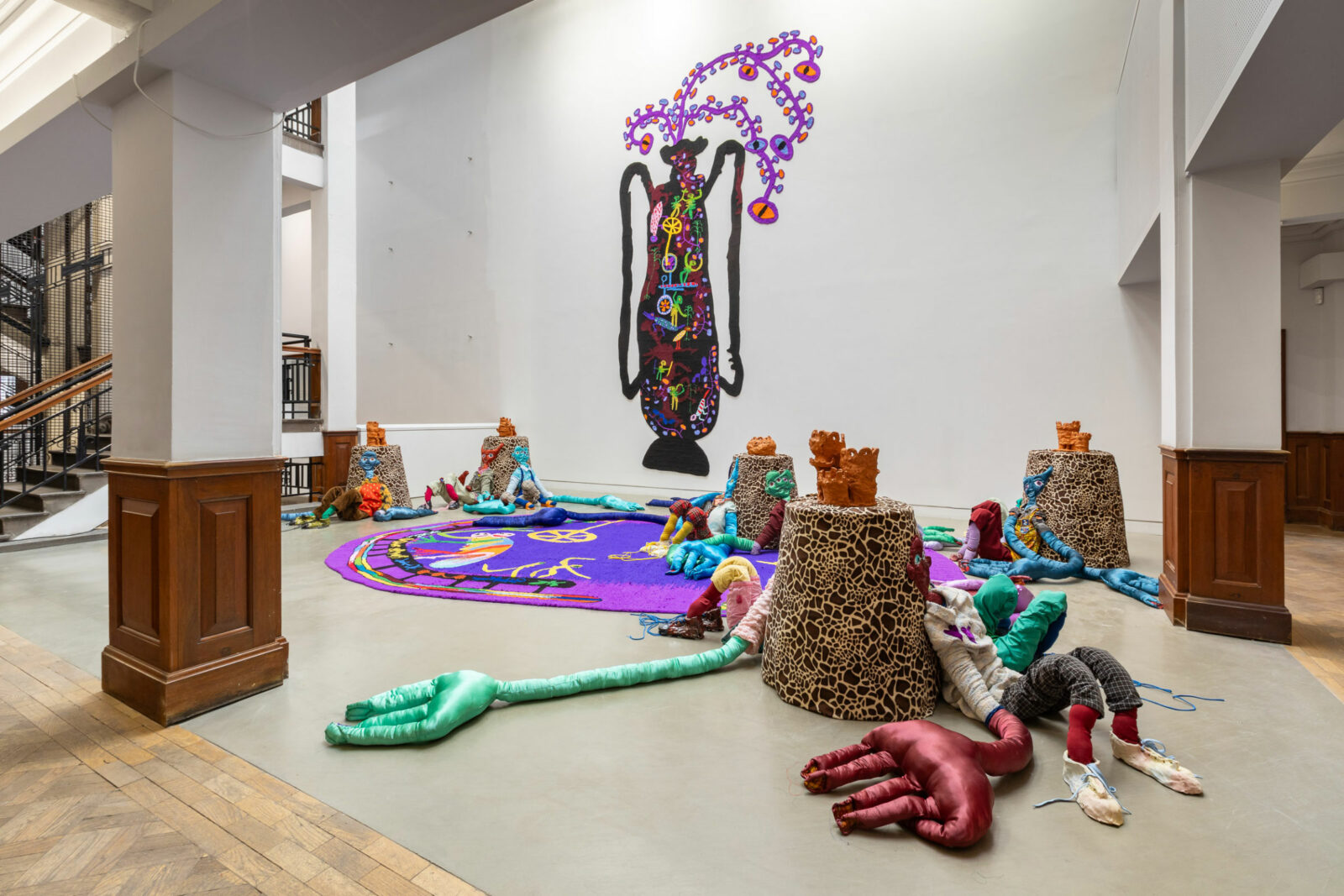 Installation view of gallery with tufted tapestries