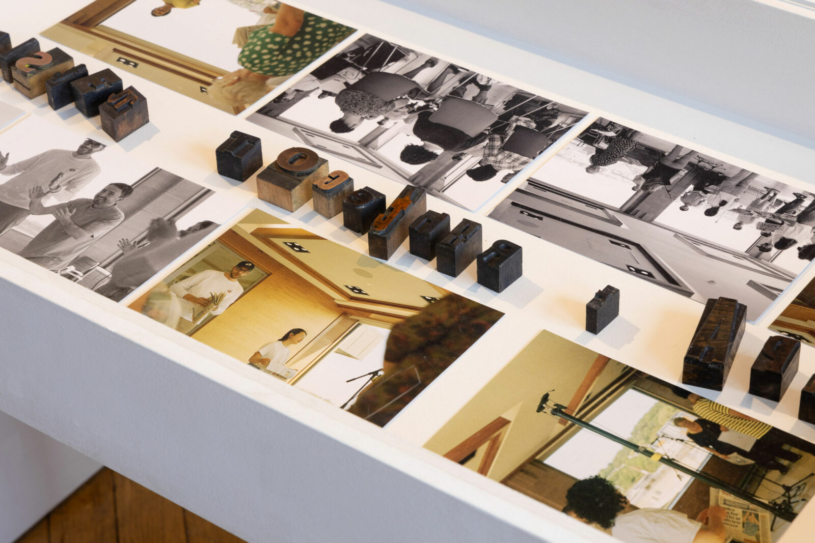 A vitrine with photographs and letter blocks