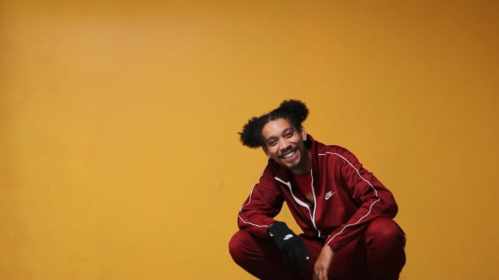 Henny Hurtz smiles against an orange background