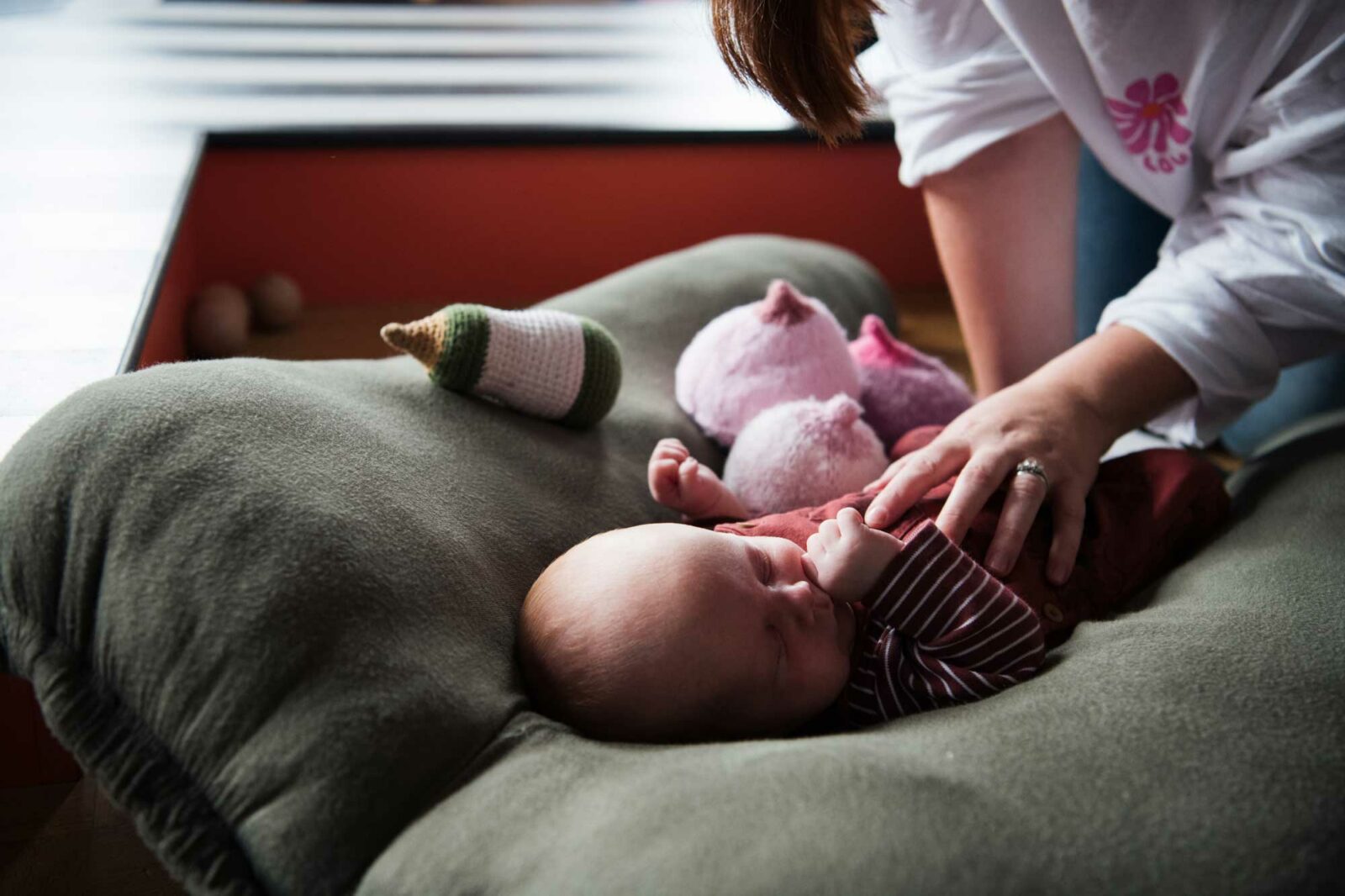 Baby surrounded by knitted boobs