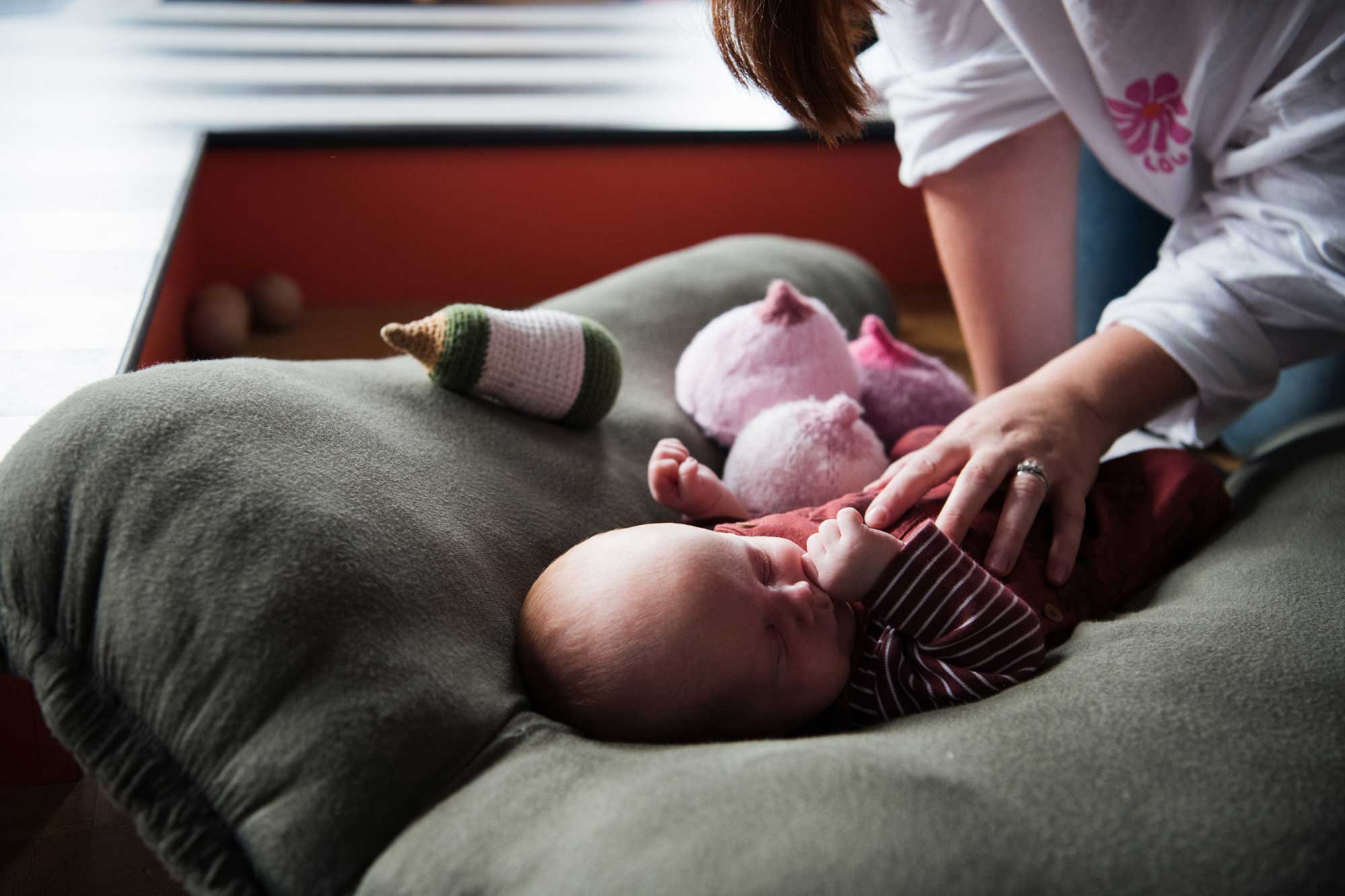 Baby surrounded by knitted boobs