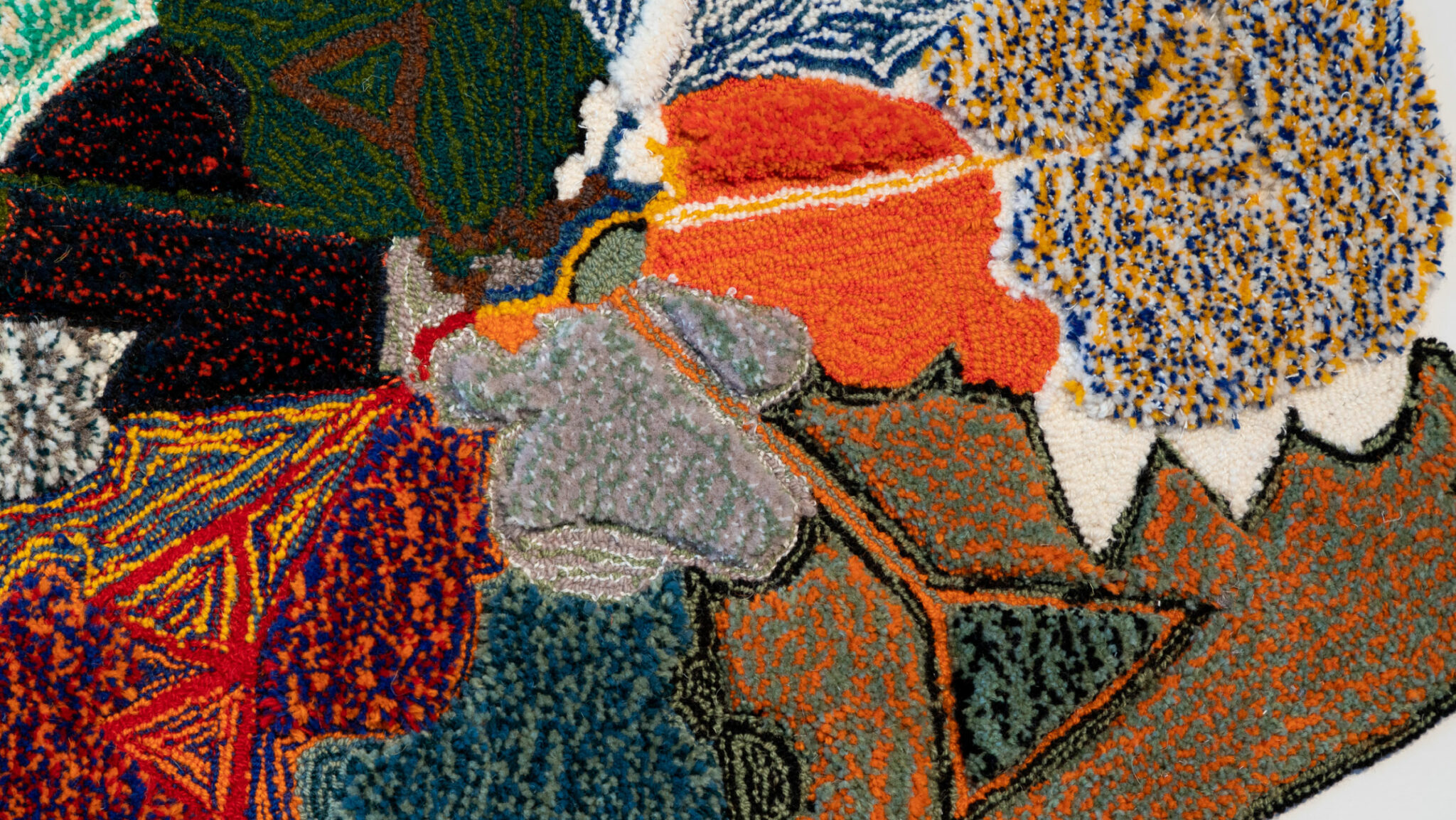 Close up detail of brightly coloured tapestry