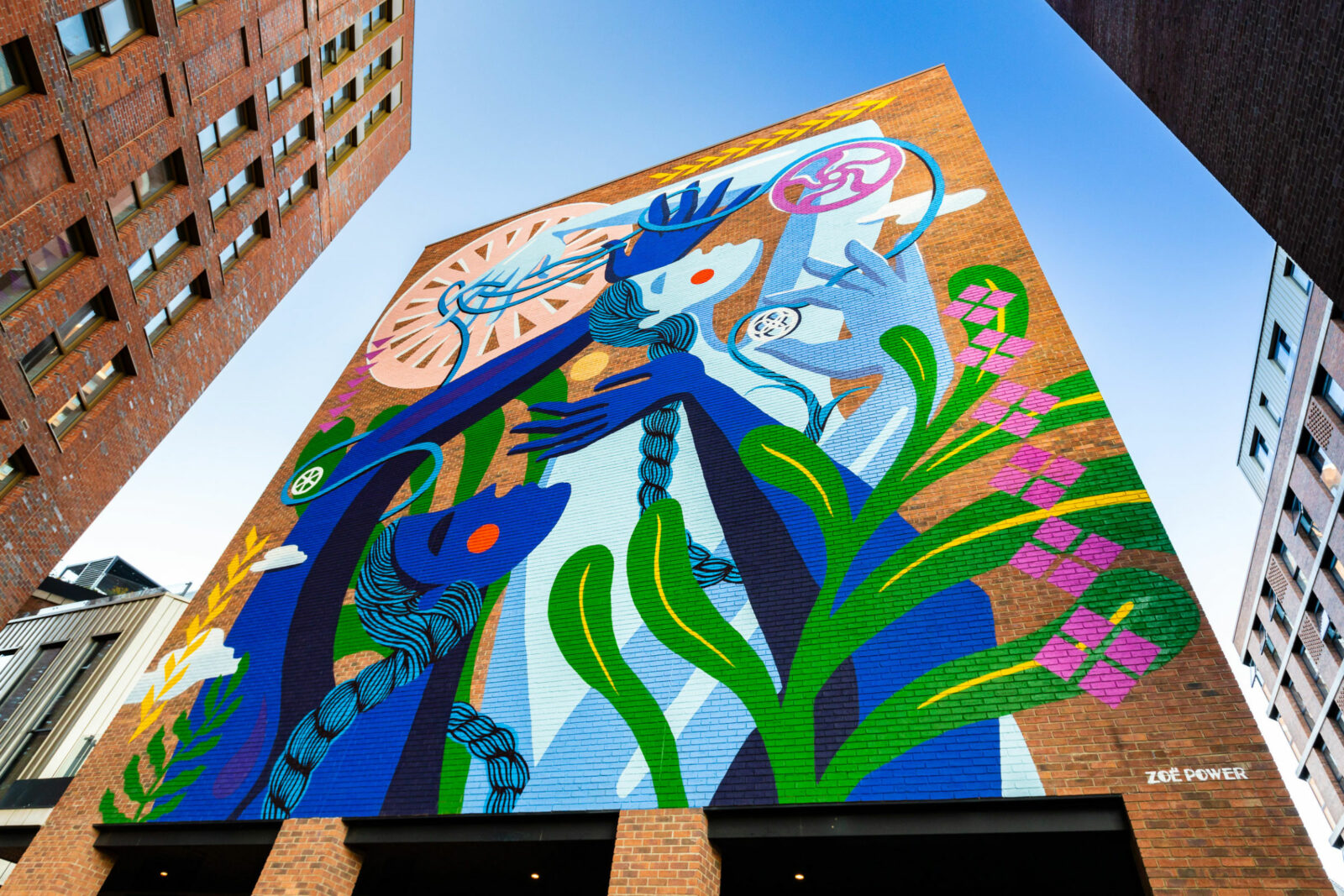 Brightly coloured mural with a figure entwined with cogs