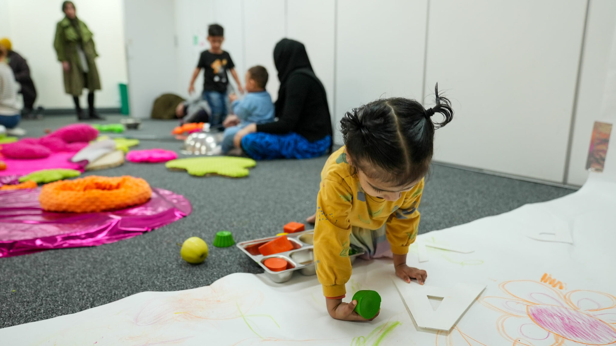 A child draws with a crayon
