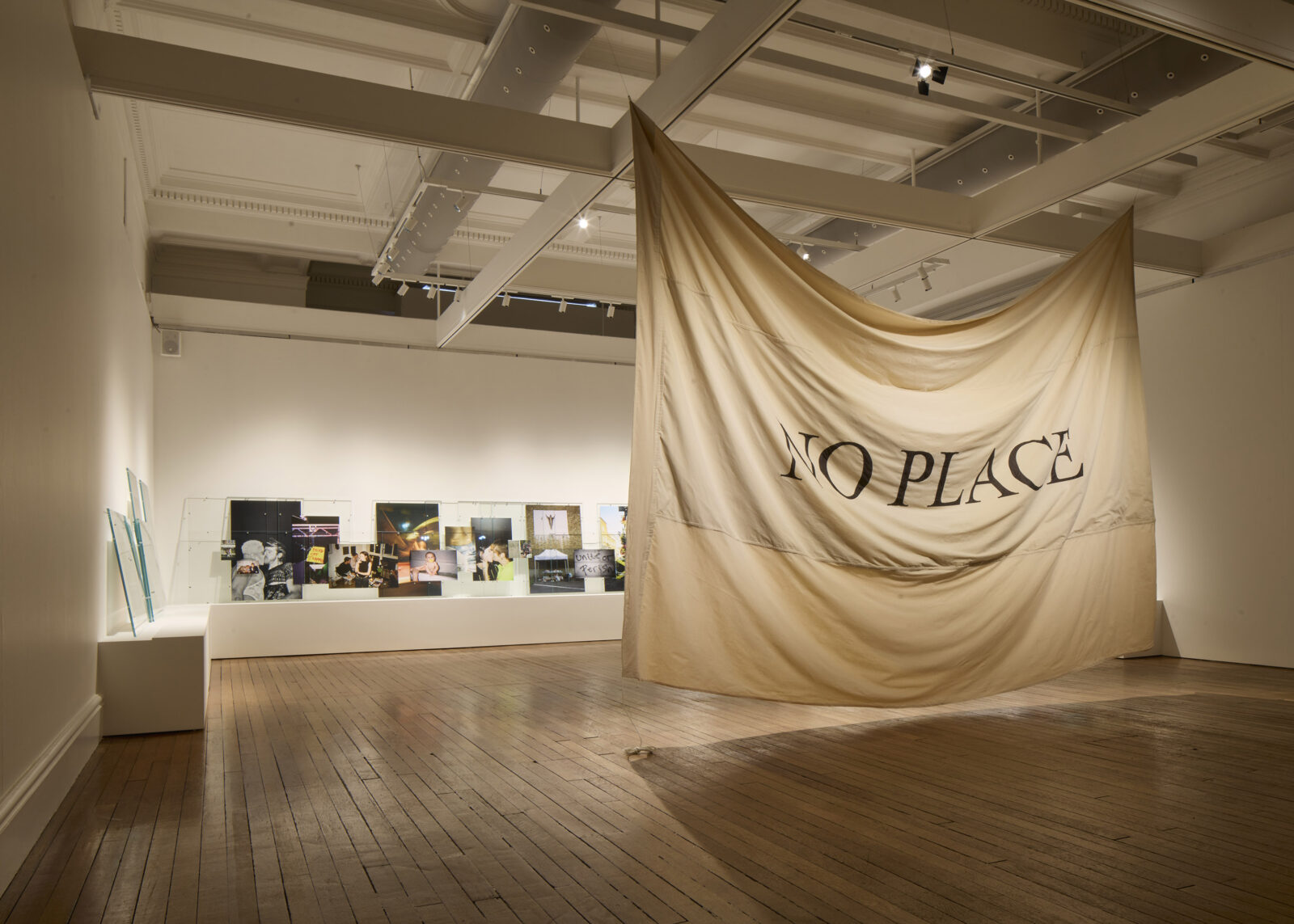 Spacious gallery with wooden floors featuring a large, draped fabric with 