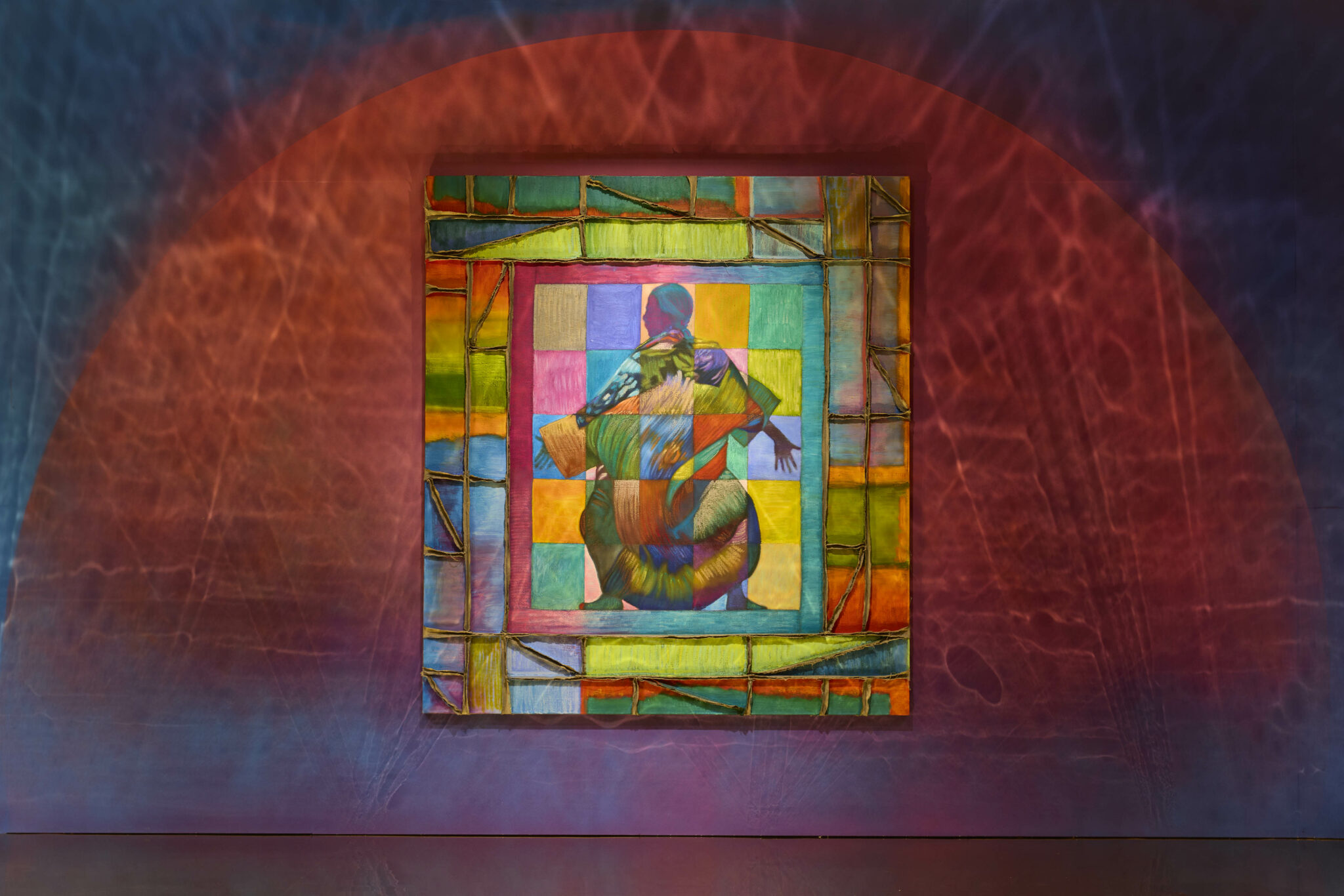 Vibrant artwork with colorful squares and abstract human figure on a rainbow background, set against a textured red and blue gradient wall.